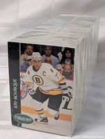 Photo showing front and side view of the 1993 Parkhurst hockey card set sealed in shrink wrap, featuring a card of Ray Bourque in Boston Bruins uniform.