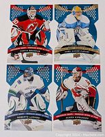 Four 2009 Upper Deck McDonalds die-cut hockey goalie insert cards featuring Martin Brodeur, Marc-Andre Fleury, Roberto Luongo, and Miikka Kiprusoff.