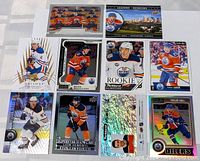 Photo of 10 Edmonton Oilers hockey cards laid out showing players in different card designs and styles