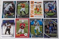 Full lot of 8 NFL football rookie cards laid out showing all players and card designs.