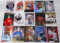 Photo showing entire lot of 15 hockey cards arranged in three rows