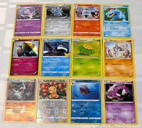 Photo showing 12 Pokémon cards, various types including holo Xerneas and holo Kyogre.