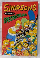 Front cover of the Simpsons Comics Spectacular graphic novel showing multiple Simpson family members in a comic strip scene.