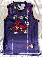 Front view of purple Vince Carter Toronto Raptors basketball jersey with tags attached