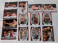 Photo showing 13 UFC fighting sports trading cards in two rows, featuring action shots and portrait cards from the UFC Contenders series.