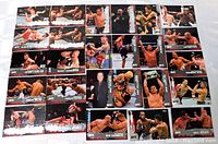 Top-down photo of 26 UFC sports trading cards arranged orderly, showing various fight moments and fighters