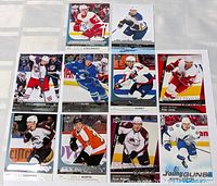 Top-down photo of 10 Upper Deck Young Guns hockey rookie cards arranged in a grid, showing players in various NHL team jerseys and action poses