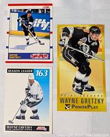Three Wayne Gretzky hockey cards shown on white surface, includes tall boy style card