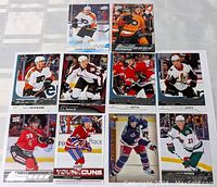 Top-down photo showing all 10 Young Guns NHL hockey rookie cards arranged in rows on a flat surface.