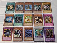 Flat lay of all 15 Yu-Gi-Oh! cards showing holographic and foil details on a white surface.