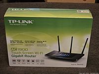 Front view of the TP-LINK router box highlighting model, AC1900 touchscreen wifi gigabit router with features like online gaming and 4K video streaming