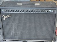 Front view of Fender FM212 DSP guitar amplifier showing full grille, Fender logo and control panel with multiple knobs.