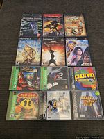 Top two rows of PlayStation 2 games on a dark fabric surface.