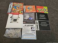 Full laid out contents showing box, manuals, inserts, white insert holder, and plastic bag