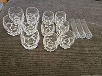 Overall shot of 11 Steuben crystal pieces including tumblers and vases