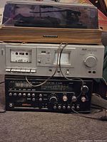 Full view of the stacked vintage electronics including turntable, cassette deck (Akai), and receiver unit
