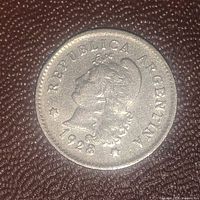 Obverse side of the 1928 Argentina coin showing the female profile with 'REPUBLICA ARGENTINA' and the year 1928.
