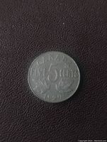 Reverse side of coin showing denomination FIVE 5 CENTS, maple leaves and year 1929