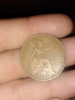 Front side of the 1935 large English penny showing Britannia sitting and the date '1935' at the bottom.