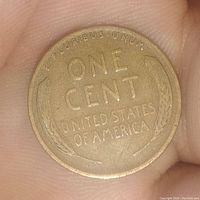 Reverse side of the 1935 Lincoln Wheat Cent coin showing 'ONE CENT' text, wheat ears, and 'UNITED STATES OF AMERICA' inscription.