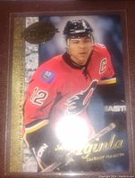 Front view of the Jarome Iginla hockey card showing him in a Calgary Flames red jersey with gold foil detailing.