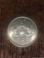 Close-up image of the reverse side of the 5 pence coin showing 'NEW PENCE', the crowned thistle emblem, and the denomination '5'.
