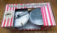 Boxed Pro Popper stove top popcorn popper set with visible packaging and contents.