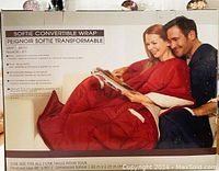 Photo of the boxed Softie Convertible Wrap/Throw showing usage as a wrap/throw with zip center and front pockets