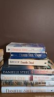 Stack of 7 Danielle Steel novels showing spines: The Good Fight, Daddy, Kaleidoscope, The Ballad, Beauchamp Hall, Message from Nam, One Day at a Time.