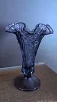 Full view of vintage purple violet glass vase showing ruffled top and stand