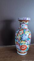 Full view of hand painted Asian porcelain floral vase showing colorful flowers and neck pattern