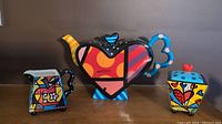 Full set with teapot, creamer, and sugar holder showing colorful Romero Britto design and shapes