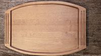 Top view of the large wooden serving tray showing shape, grooved handles, and wood surface.