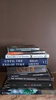 Stack of eight non fiction books showing titles and authors.