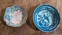 Two bowls side by side: Toyo golden peony floral hand painted bowl on left, blue and white peacock and cherry blossom bowl on right.