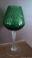 Front view of green Empoli glass vase showing bubble texture and twisted clear stem.