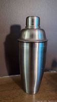 Photo of the cocktail shaker assembled, showing the full polished stainless steel exterior.