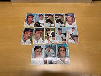 Top view of 13 vintage 1964 Topps large baseball cards arranged in three rows showing players' portraits and names.