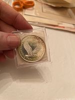 Obverse side of the 1987 silver medallion showing an eagle with wings outstretched and inscriptions including 'UNITED STATES OF AMERICA' and 'ONE TROY OUNCE .999 FINE SILVER'