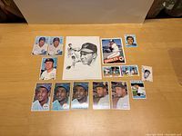 Full lot arranged on a wooden surface, showing all cards including 1964 Topps headline cards, uncut strip, printed image, and oversized card.
