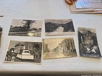 Photo showing five different vintage black and white postcards depicting Wisconsin landscapes and town scenes including park, street with buildings, parade float, and cave formations.