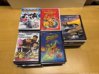 Top view showing a selection of DVDs including Happy Feet, It's a Small World of Fun, Free Willy 2, Despicable Me, Scooby-Doo Adventures