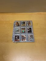 Top view of cards in protective sheets showing a group of nine cards per page with Marine illustrations.