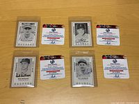 Four autographed 1979 Donruss baseball cards featuring New York Dodgers players alongside their certificates of authenticity, displayed on a wood surface.