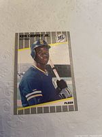 Clear image of the front of the Ken Griffey Jr. Fleer rookie card, showing subject in Mariners uniform with bat, card number 548.
