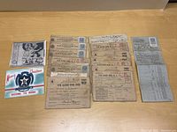 Photo showing the collection of WWII war ration booklets, V-Fuel oil ration card, and a Christmas V-Mail card laid out on a wooden surface.