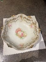 Overhead view of porcelain bowl showing central floral design and gold trim