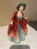 Front view of Royal Doulton Margaret figurine showing detailed face, hat, and clothing.