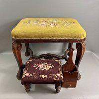 Front view of large stool with yellow floral upholstery and small footstool with dark floral upholstery and wood magazine holder side