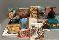 Full view of the 13 different art books arranged in rows